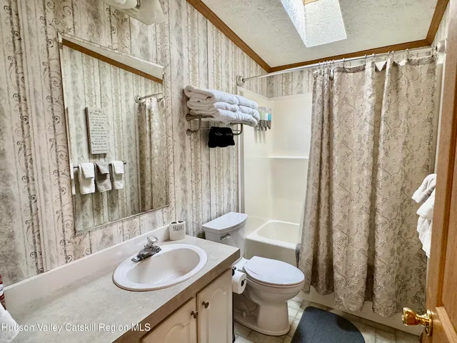 a bedroom with a bed and a mirror