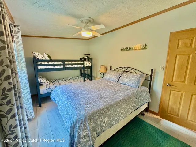 a bed sitting in a bedroom next to a window