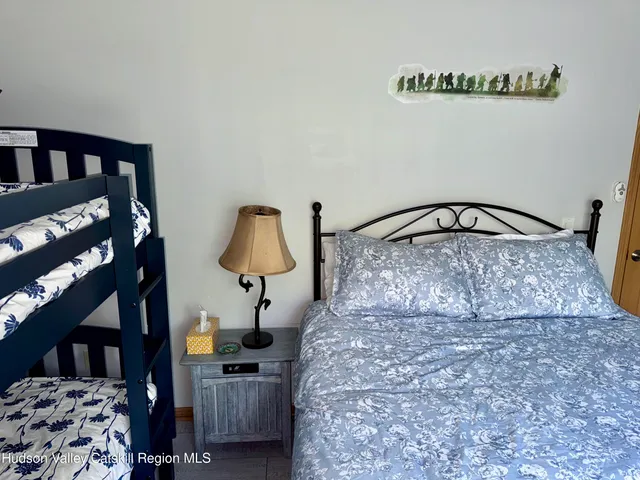 a large bed sitting in a bedroom next to a window