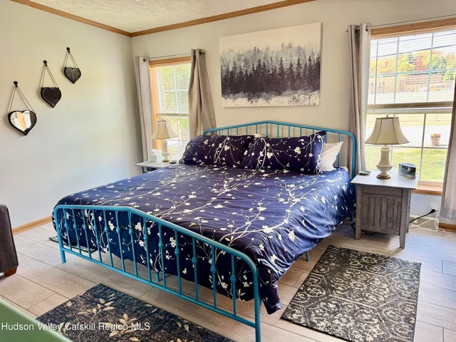 a bedroom with a bed and a flat screen tv