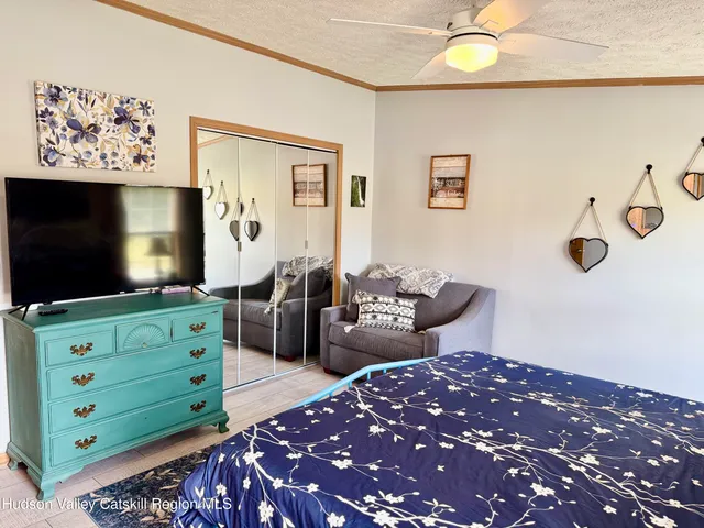 a bedroom with a large bed and a window