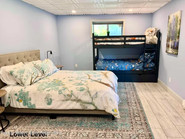 a large bed sitting in a bedroom next to a lamp