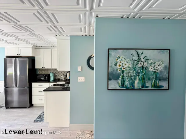 a kitchen with a stove a refrigerator and a table