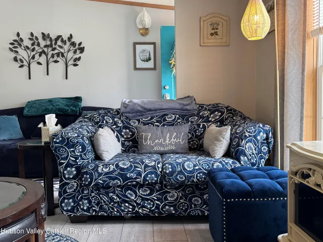 a bedroom with a bed couch and a window