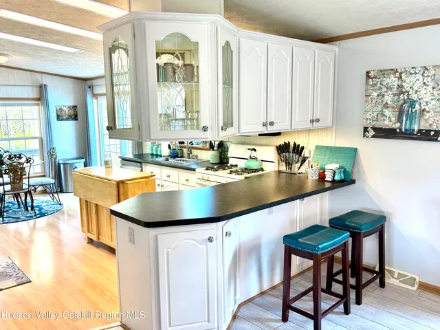 a kitchen with a sink cabinets and window