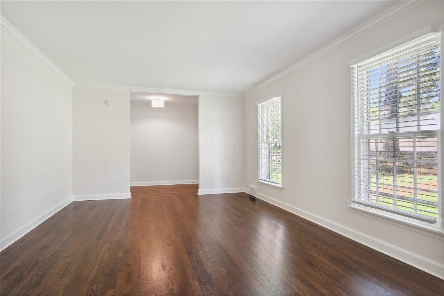 232 South Yates Road Memphis, TN 38120 - Photo 8 of 29 an empty room with wooden floor and windows