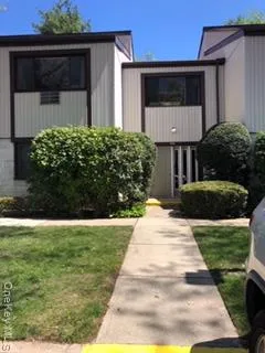 a view of house with backyard and garden