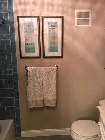 a bathroom with a toilet a sink and a mirror