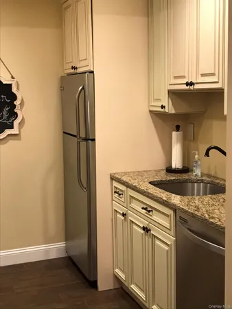 a kitchen with stainless steel appliances granite countertop a refrigerator and a stove