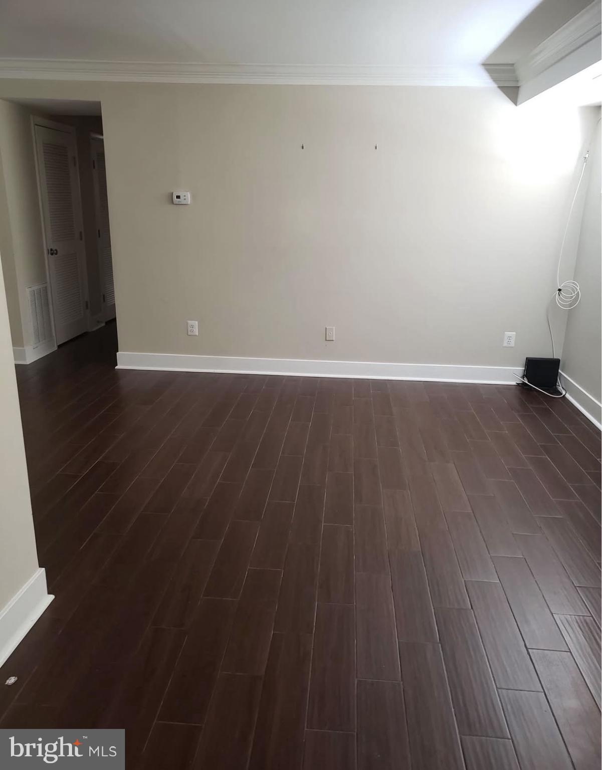 4102 Queensbury Road Hyattsville, MD 20781 - Photo 5 of 6 a view of an empty room with wooden floor