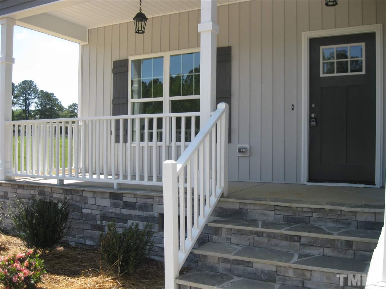 Enjoying spending time on this lovely covered front porch, accented with beautiful stonework