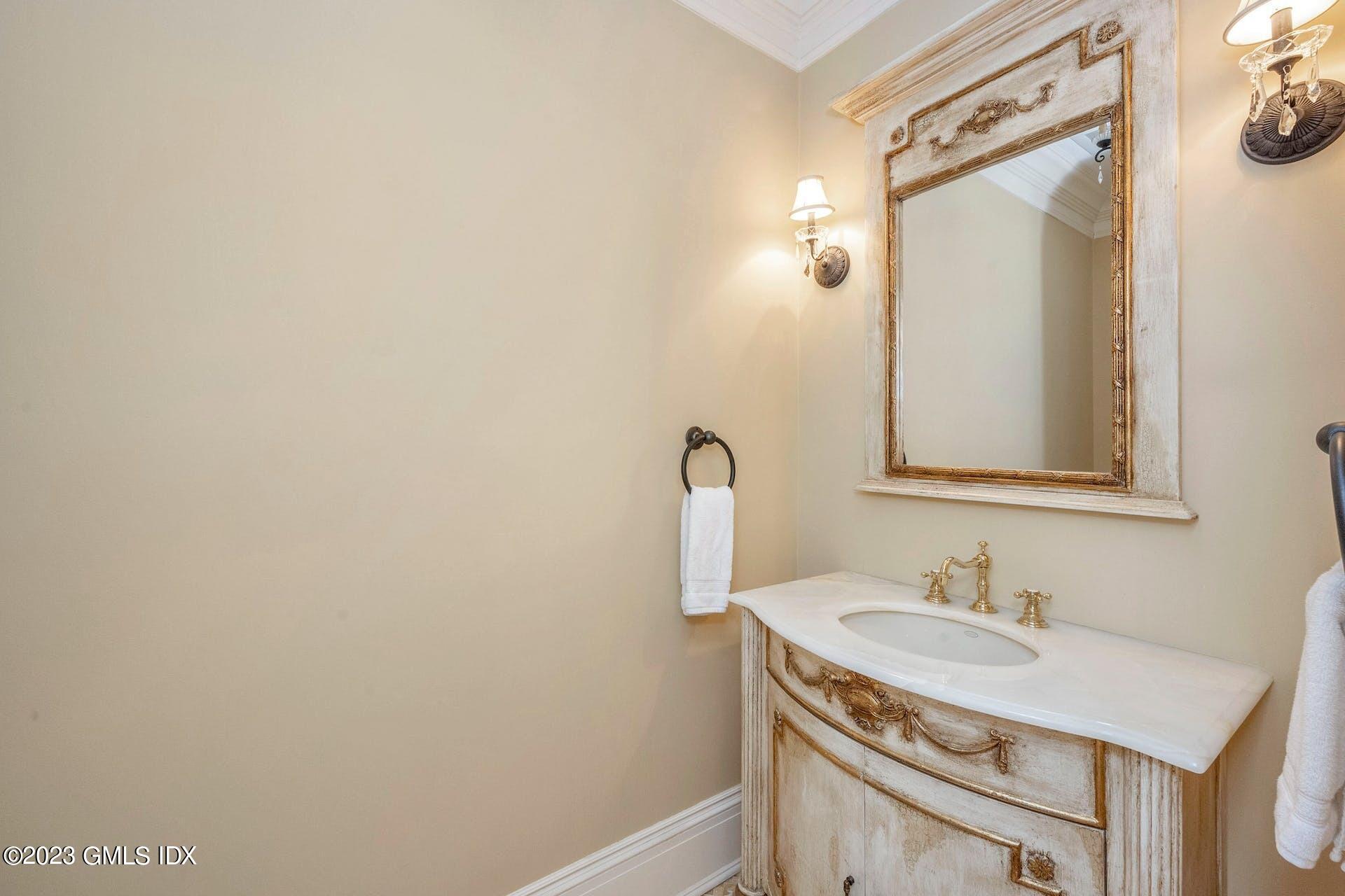 53 Hillside Road Greenwich, CT 06830 - Photo 13 of 37 a bathroom with a sink vanity and a mirror