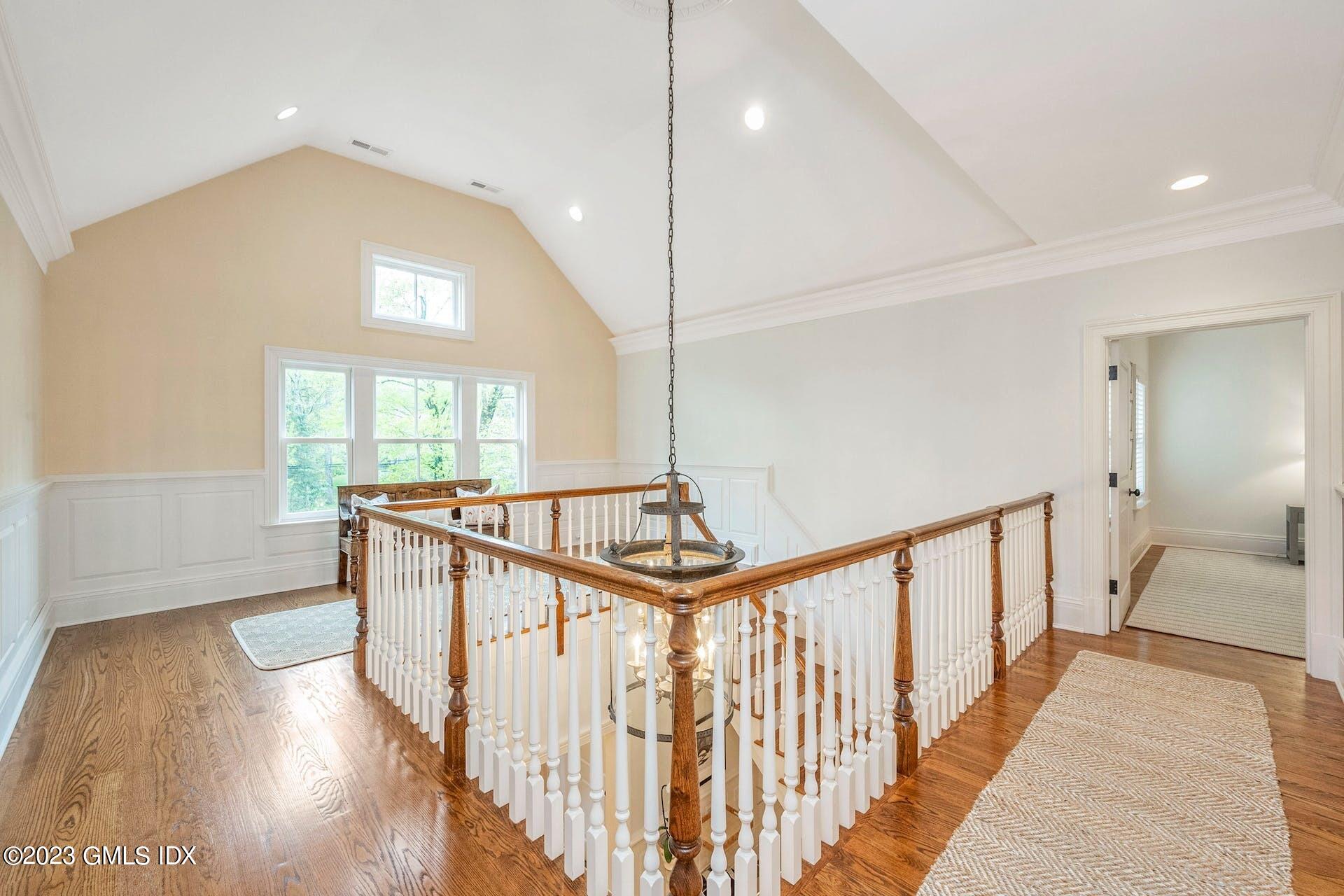 53 Hillside Road Greenwich, CT 06830 - Photo 15 of 37 a view of a hallway with wooden floor and windows