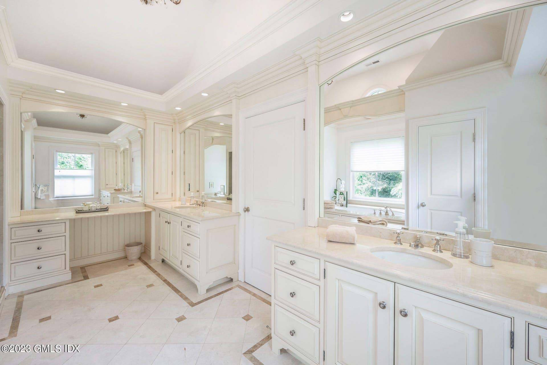 53 Hillside Road Greenwich, CT 06830 - Photo 17 of 37 a bathroom with a granite countertop sink mirror and a