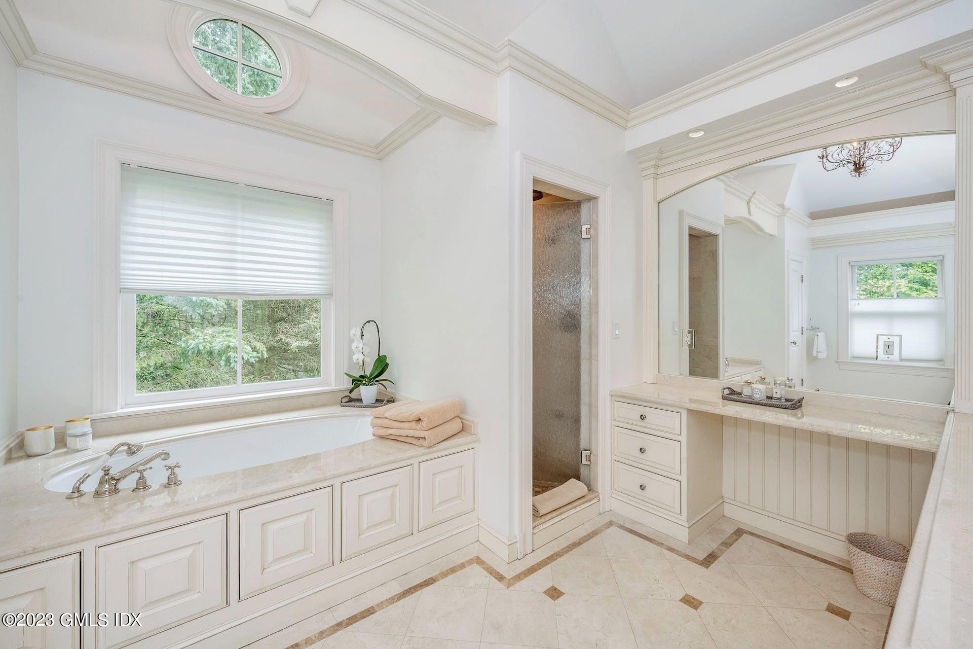 53 Hillside Road Greenwich, CT 06830 - Photo 18 of 37 a bathroom with a sink a vanity and a mirror
