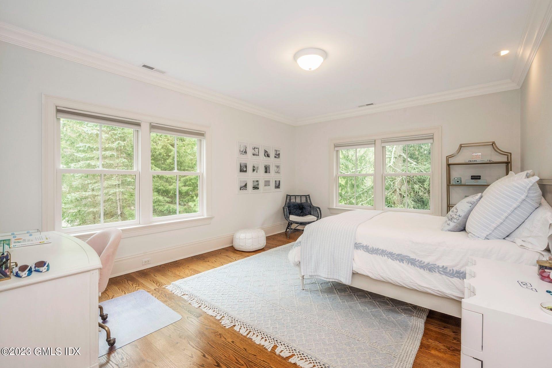 53 Hillside Road Greenwich, CT 06830 - Photo 20 of 37 a bed room with a bed and a large window