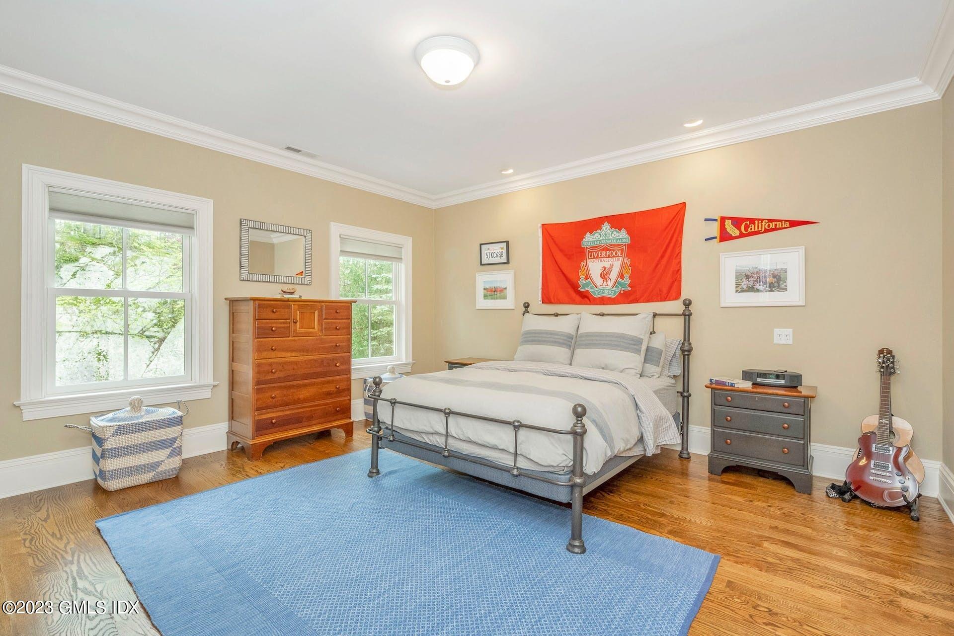 53 Hillside Road Greenwich, CT 06830 - Photo 21 of 37 a bedroom with a bed and wooden floor