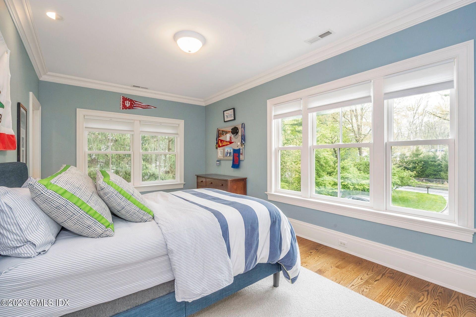 53 Hillside Road Greenwich, CT 06830 - Photo 22 of 37 a bedroom with a bed and a large window