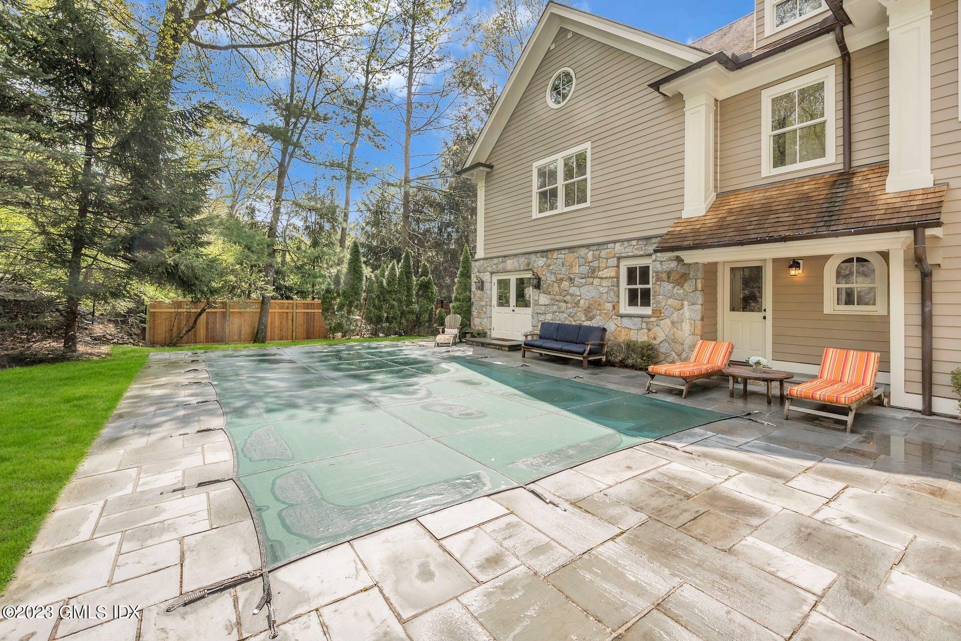 53 Hillside Road Greenwich, CT 06830 - Photo 30 of 37 a view of a house with a small yard and sitting area