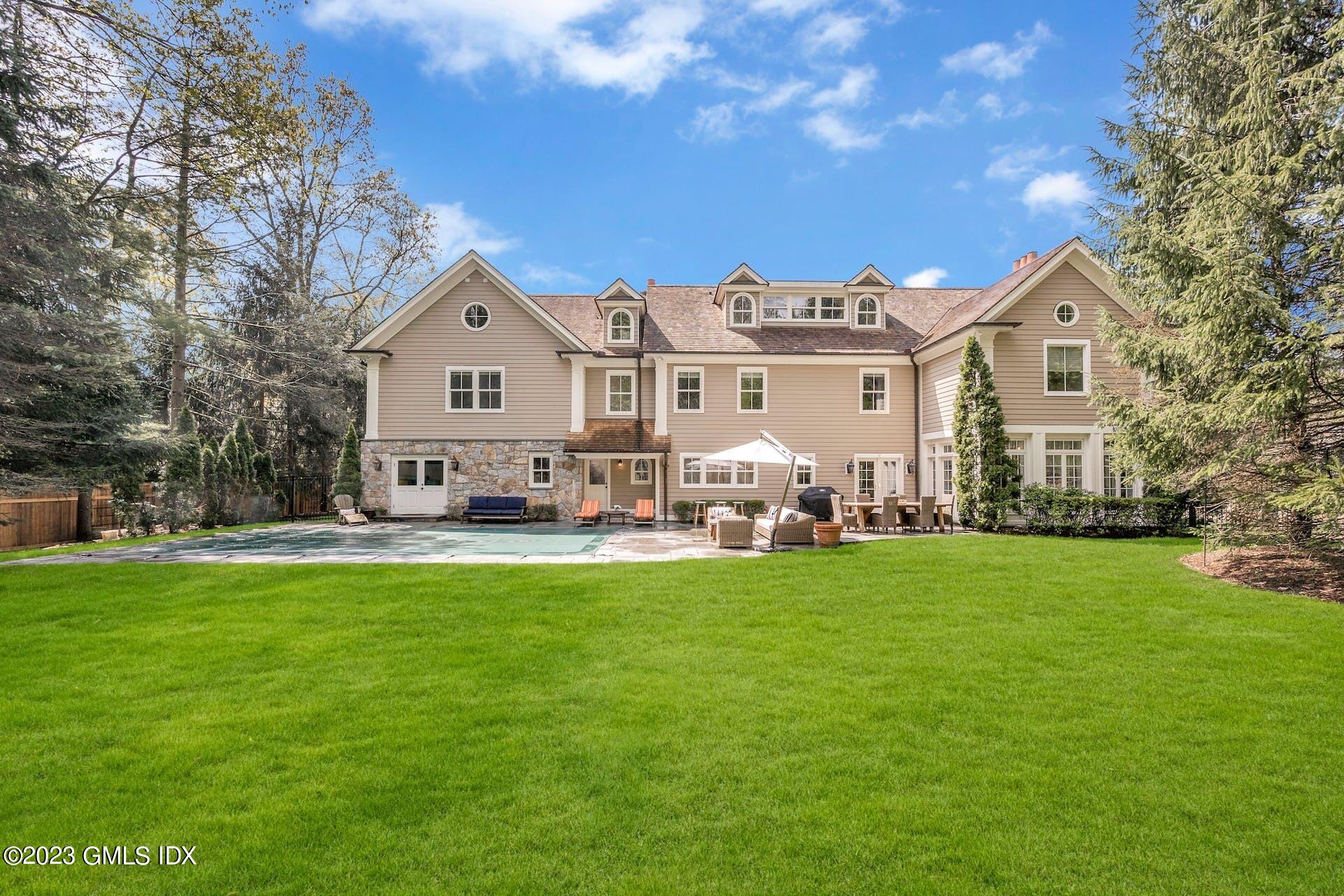 53 Hillside Road Greenwich, CT 06830 - Photo 31 of 37 a front view of a house with a garden and trees