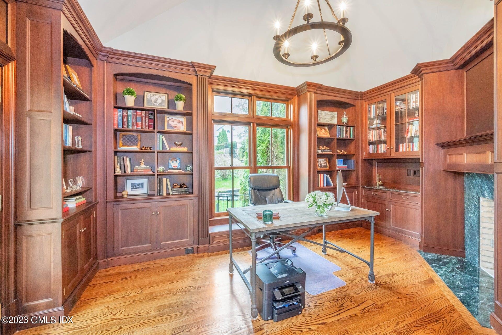53 Hillside Road Greenwich, CT 06830 - Photo 10 of 37 a living room with furniture a large window and bookshelf