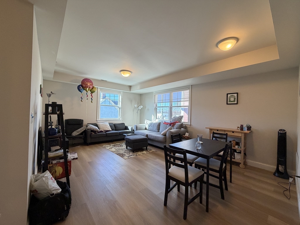 a living room with furniture a flat screen tv and a window