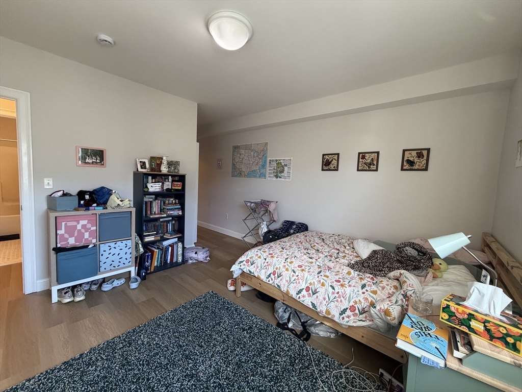 43 Pitman Street, Unit 302 Somerville, MA 02143 - Photo 11 of 14 a bedroom with a bed and dresser