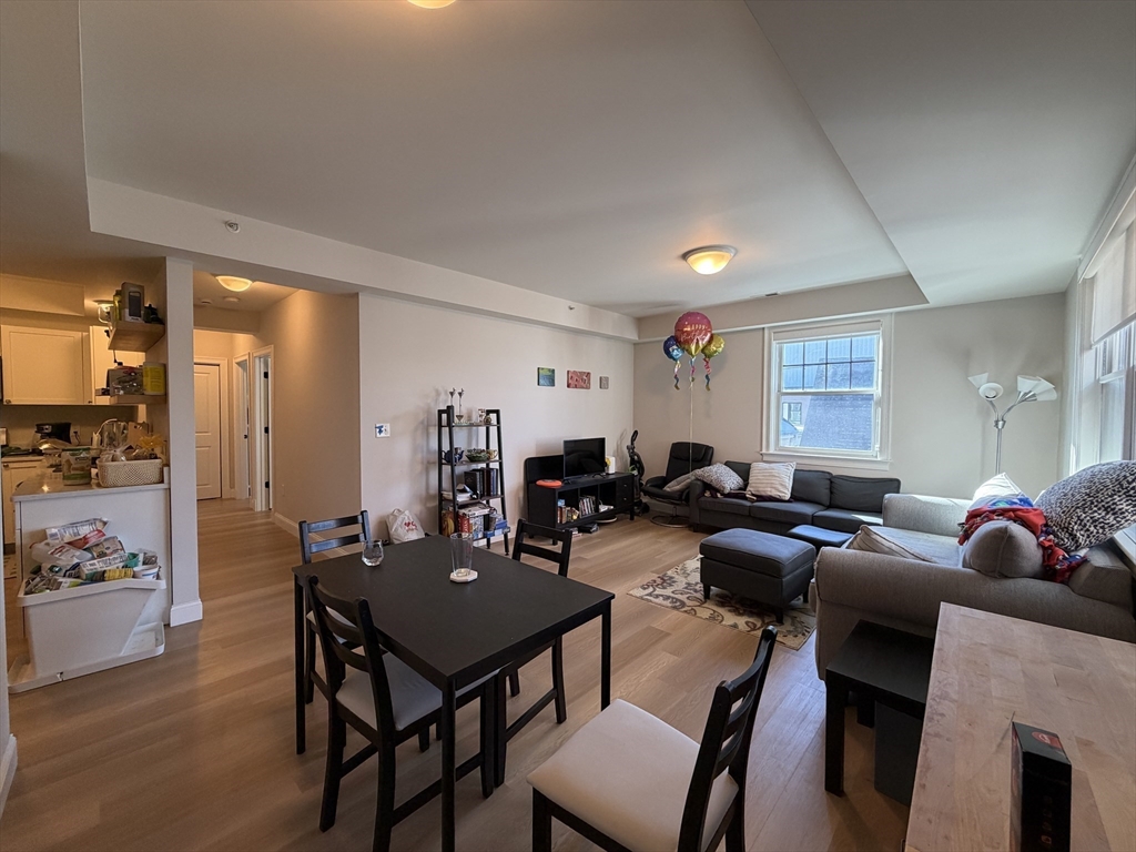 43 Pitman Street, Unit 302 Somerville, MA 02143 - Photo 2 of 14 a living room with furniture kitchen view and a window