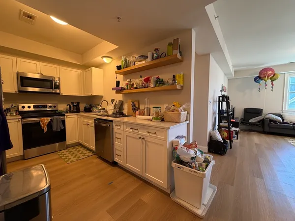 a kitchen with a stove top oven and cabinets