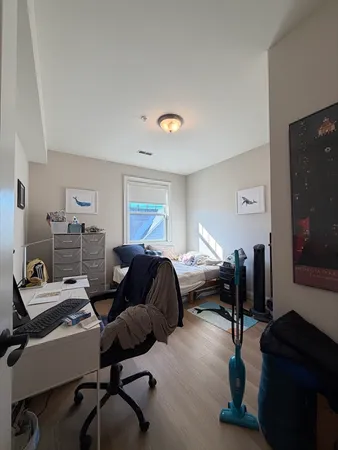 a bedroom with furniture and a window