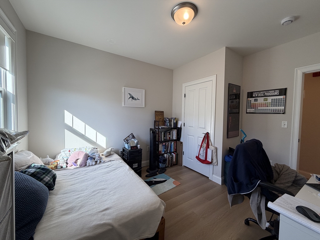 43 Pitman Street, Unit 302 Somerville, MA 02143 - Photo 9 of 14 a bedroom with bed and a large window