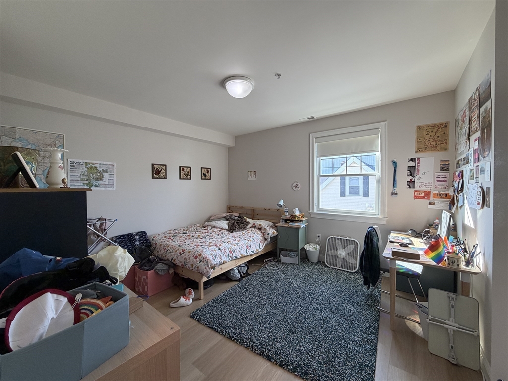 43 Pitman Street, Unit 302 Somerville, MA 02143 - Photo 10 of 14 a living room with furniture and a window