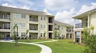 a front view of a building with a garden