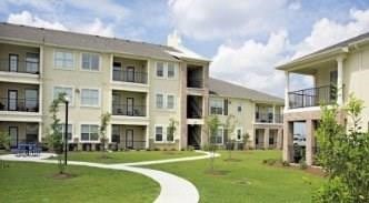 a front view of a building with a garden