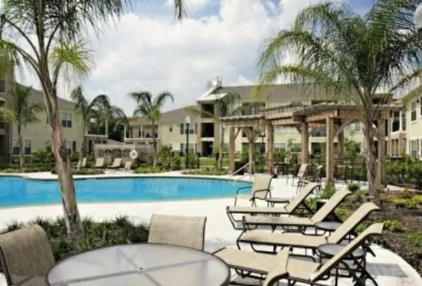 a view of a chairs and table in patio with a lake view