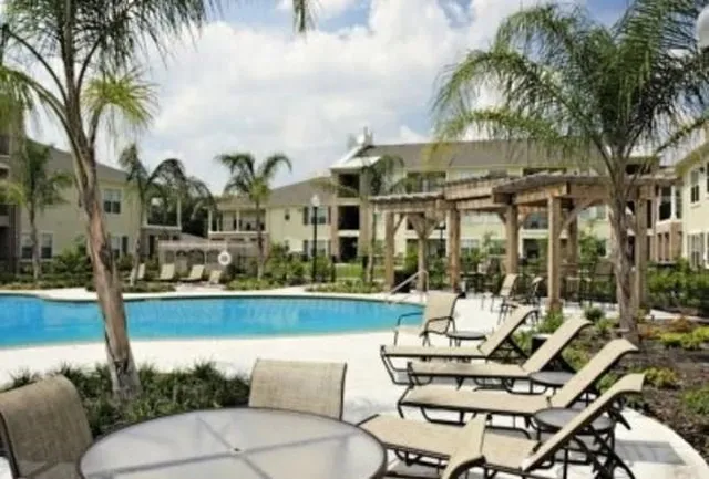 a view of a chairs and table in patio with a lake view