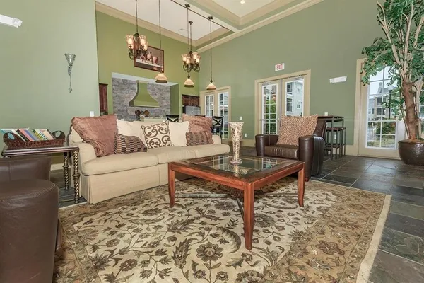 a living room with furniture and a rug