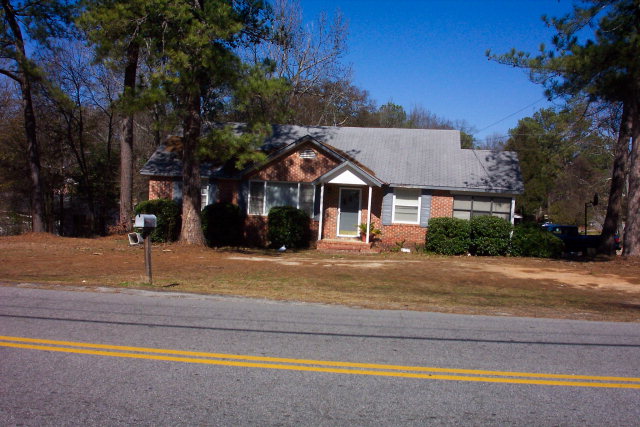 a house with trees in the background