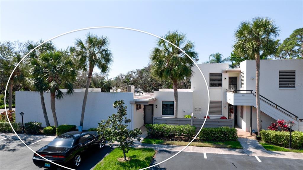 a house with a large pool and lawn chairs under an umbrella