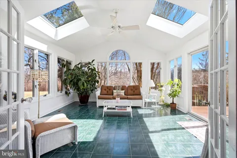 a living room with furniture a chandelier and a rug