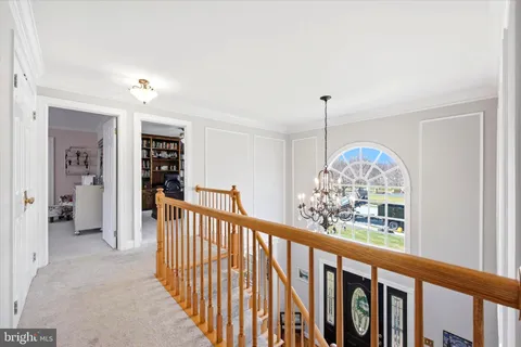 a view of a livingroom with wooden floor and stairs