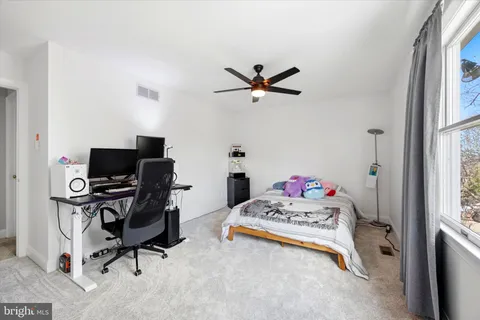 a bedroom with a workspace