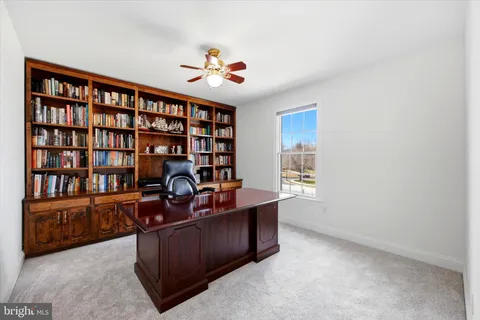 a work room with furniture and book shelf