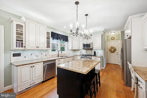 a open kitchen with a sink stove and refrigerator