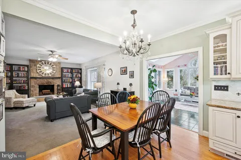 a view of a dining room with furniture a chandelier and wooden floor