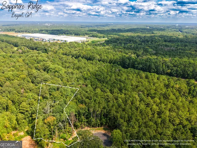 a view of a big yard with lots of green space