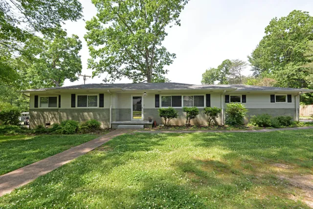 a front view of house with a garden and patio
