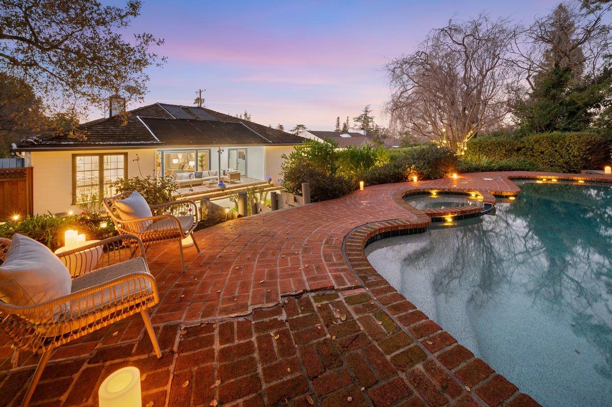 1277 Edgewood Road Redwood City, CA 94062 - Photo 1 of 49 a view of a swimming pool with lounge chairs