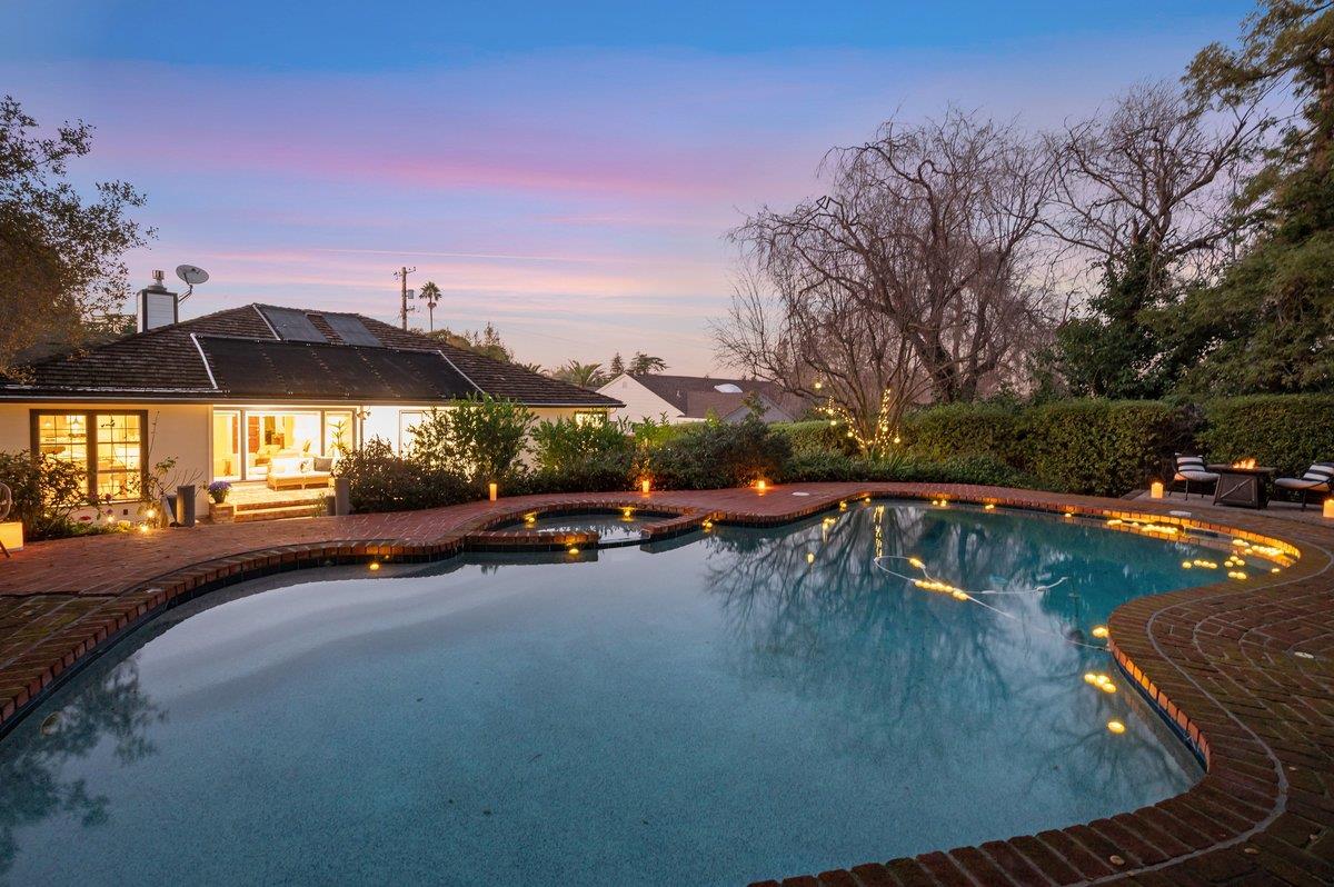 1277 Edgewood Road Redwood City, CA 94062 - Photo 2 of 49 a view of a swimming pool with an outdoor seating