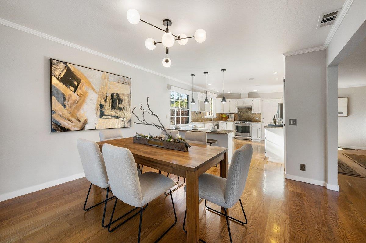 1277 Edgewood Road Redwood City, CA 94062 - Photo 21 of 49 a view of a dining room with furniture wooden floor and a chandelier